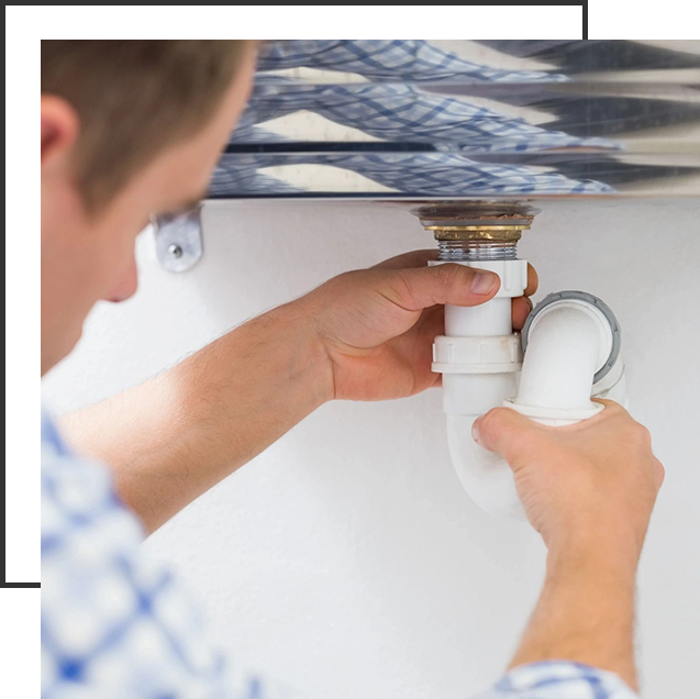 A person fixing the faucet of a sink.