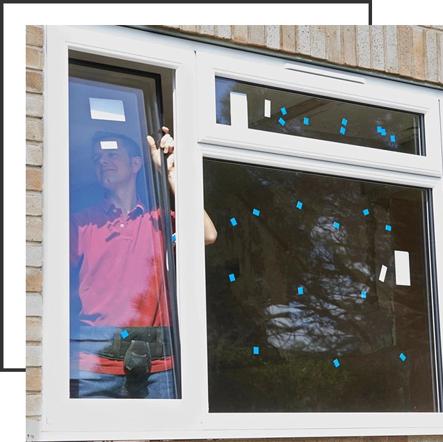 A person is standing in front of a window.